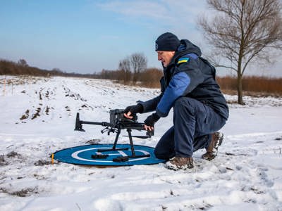 HALO team member setting up a drone in the snow